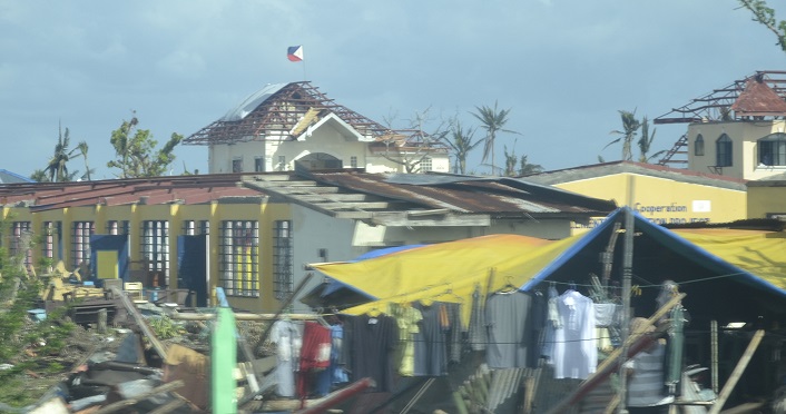 Philippine Flag flies proudly above the destruction photo